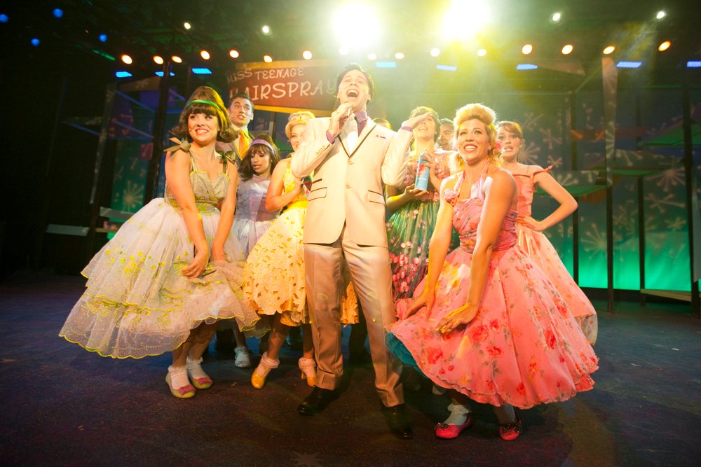 Performers singing on stage