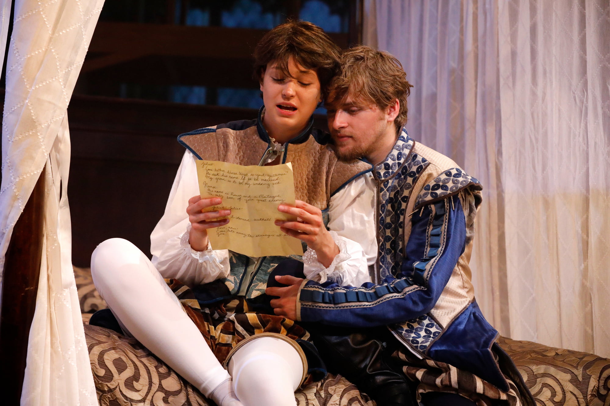 Two actors embrace in a rendition of Romeo & Juliet