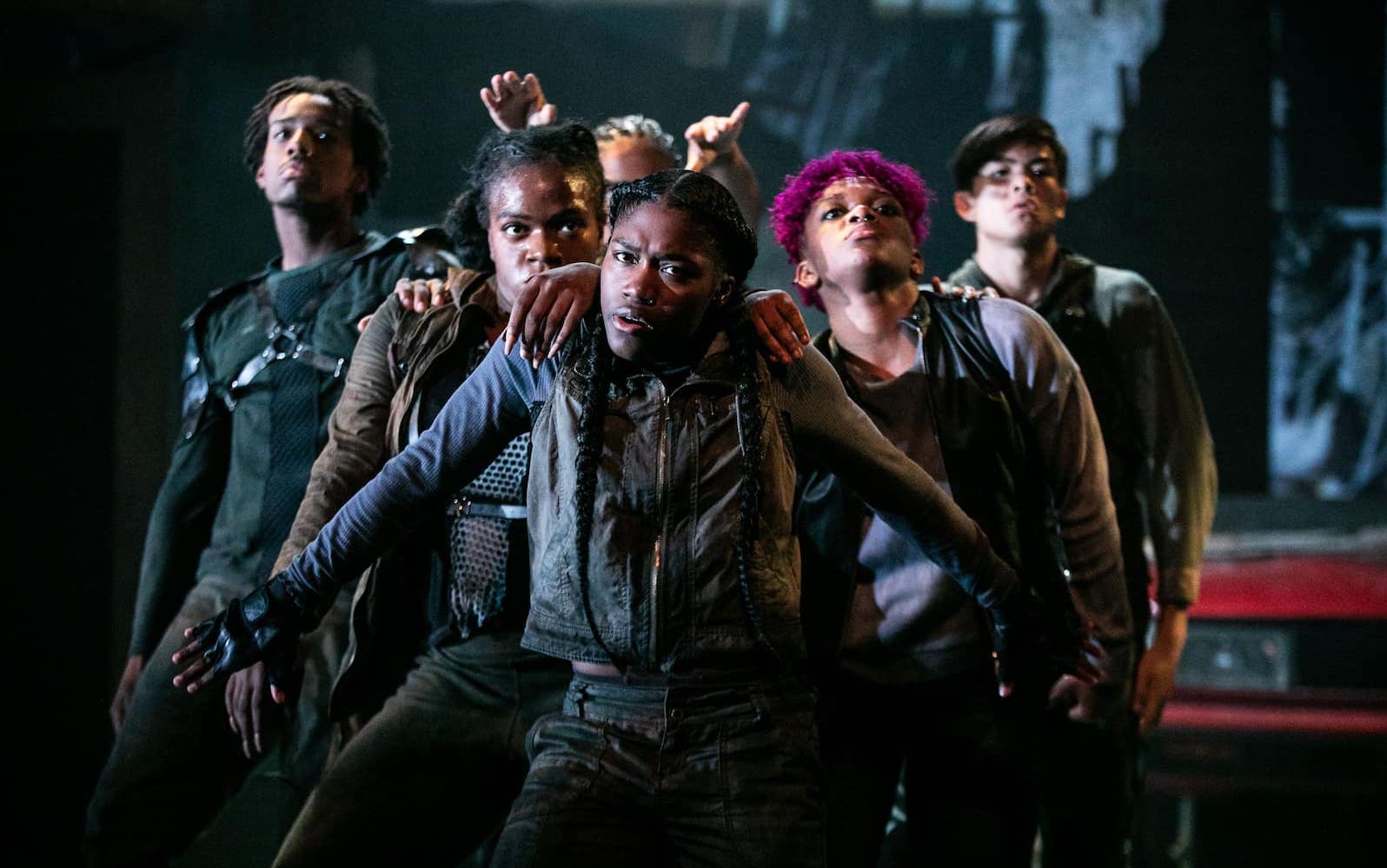 A troupe of dancers form a v-formation